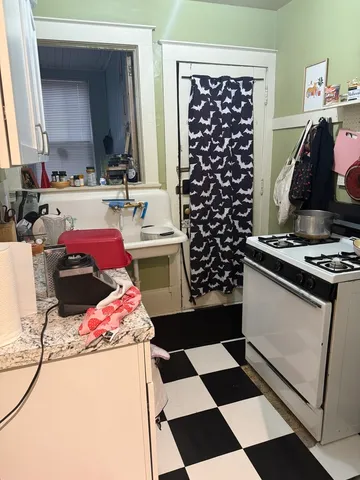 a kitchen with a stove a sink and a refrigerator
