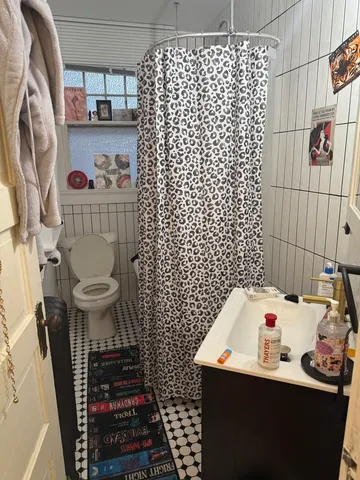 a bathroom with a sink toilet and shower