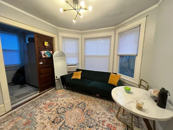 a living room with furniture and a rug