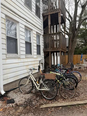 a view of a chairs and a table in the back yard of the house