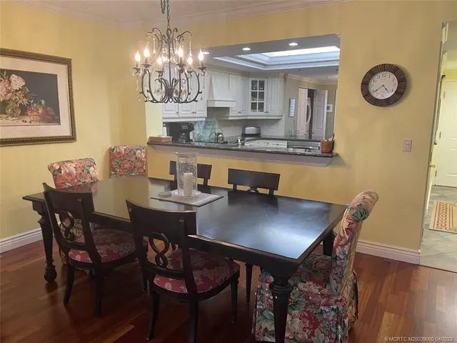 a living room with furniture a flat screen tv and kitchen view