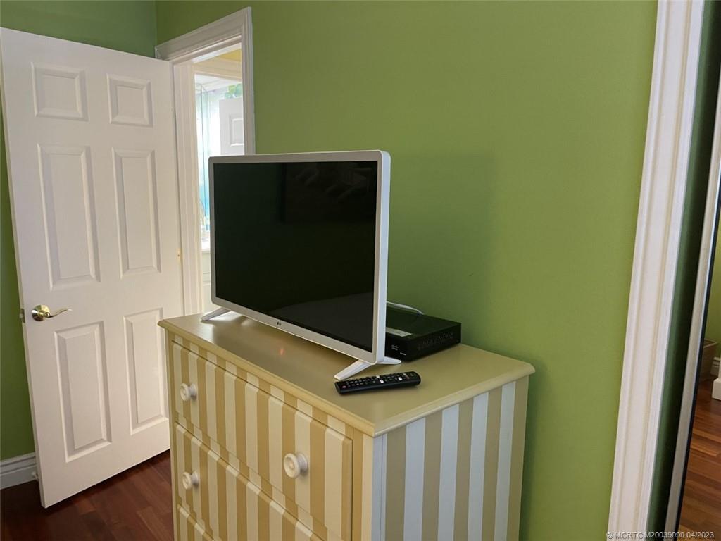 144 Northeast Edgewater Drive, Unit 3102 Stuart, FL 34996 - Photo 16 of 23 a living room with a wooden floor