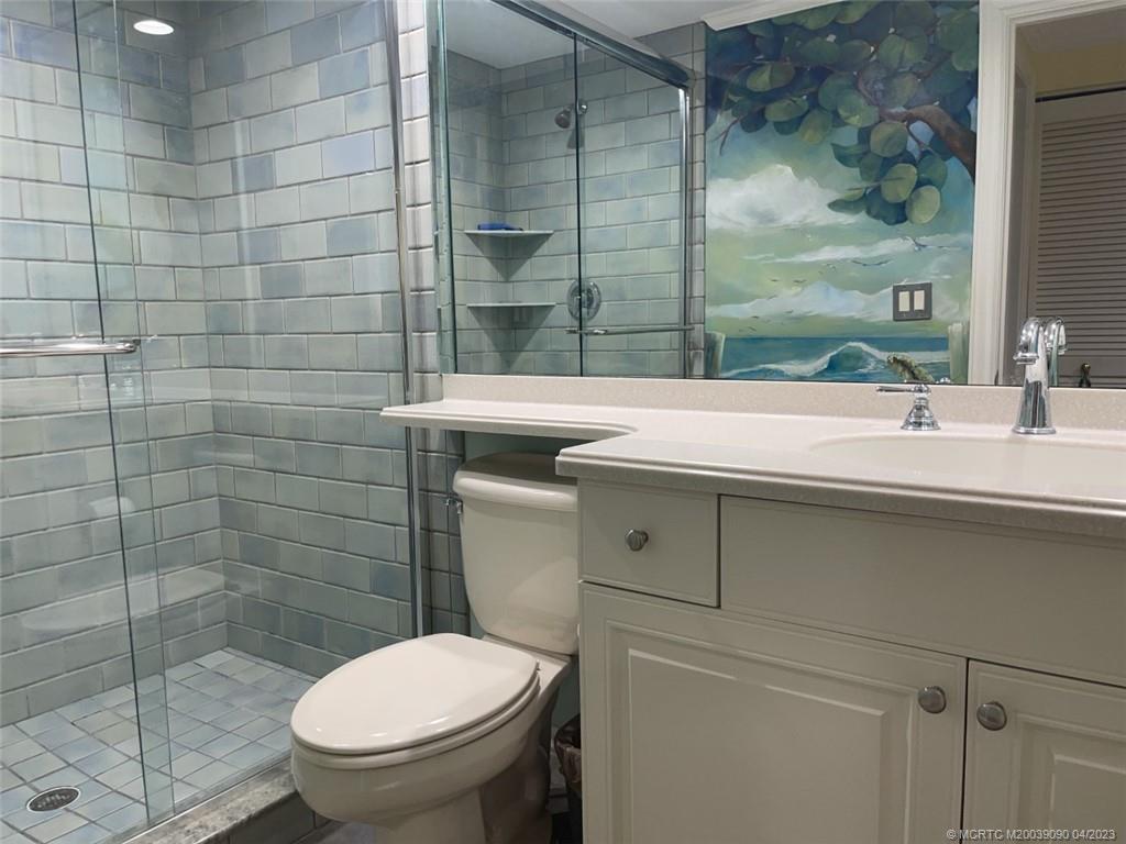 144 Northeast Edgewater Drive, Unit 3102 Stuart, FL 34996 - Photo 17 of 23 a bathroom with a sink toilet and shower