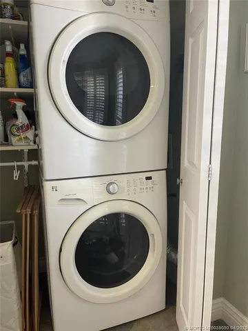 a view of a patio with table and chairs potted plants with wooden floor and fence