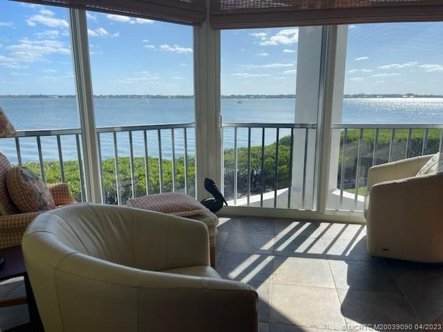 144 Northeast Edgewater Drive, Unit 3102 Stuart, FL 34996 - Photo 2 of 23 a living room with couch and a window