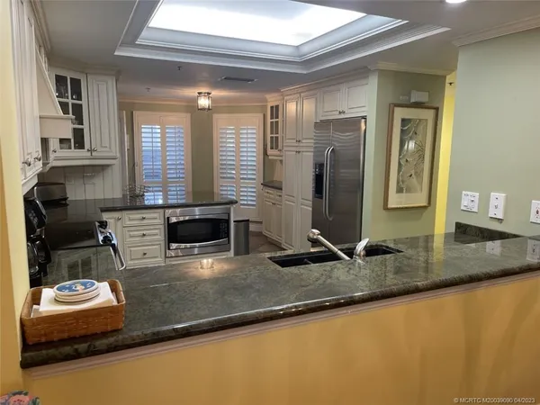a kitchen with sink refrigerator and stove