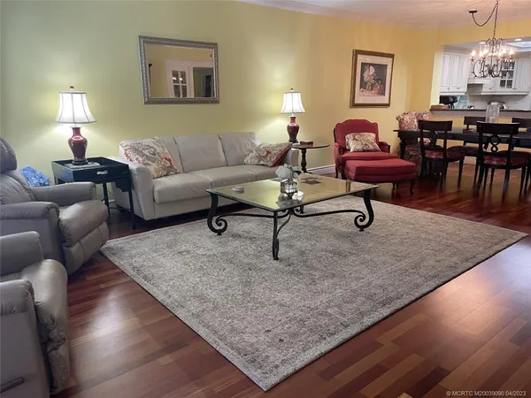 a living room with furniture and a lamp