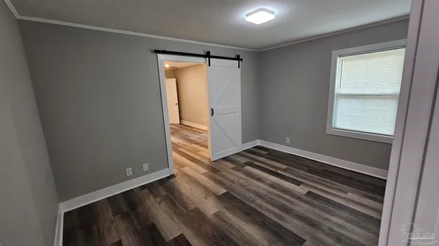 a view of a room with wooden floor and staircase