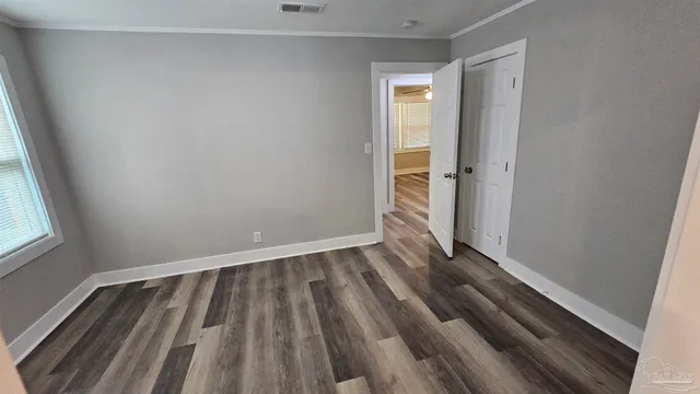 a view of wooden floor in an empty room