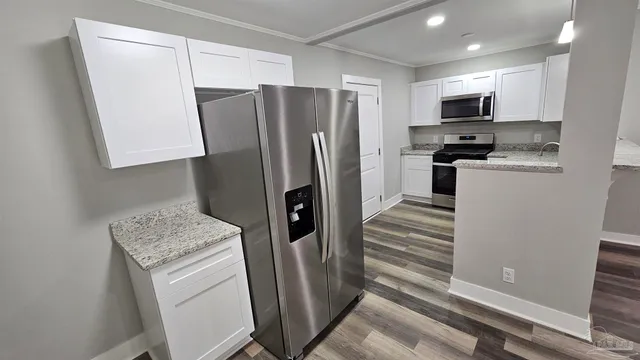 a kitchen with a refrigerator sink and microwave
