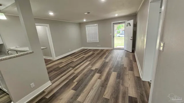 a view of a room with wooden floor and window