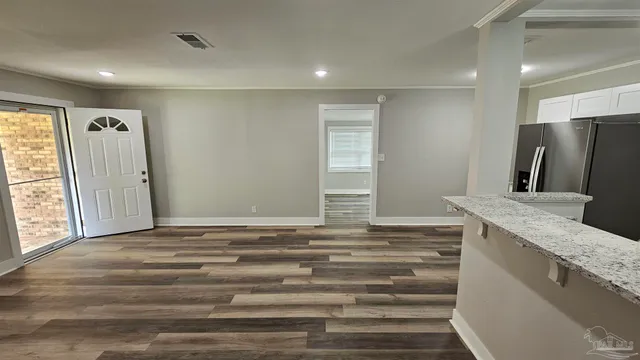 a view of kitchen and empty room