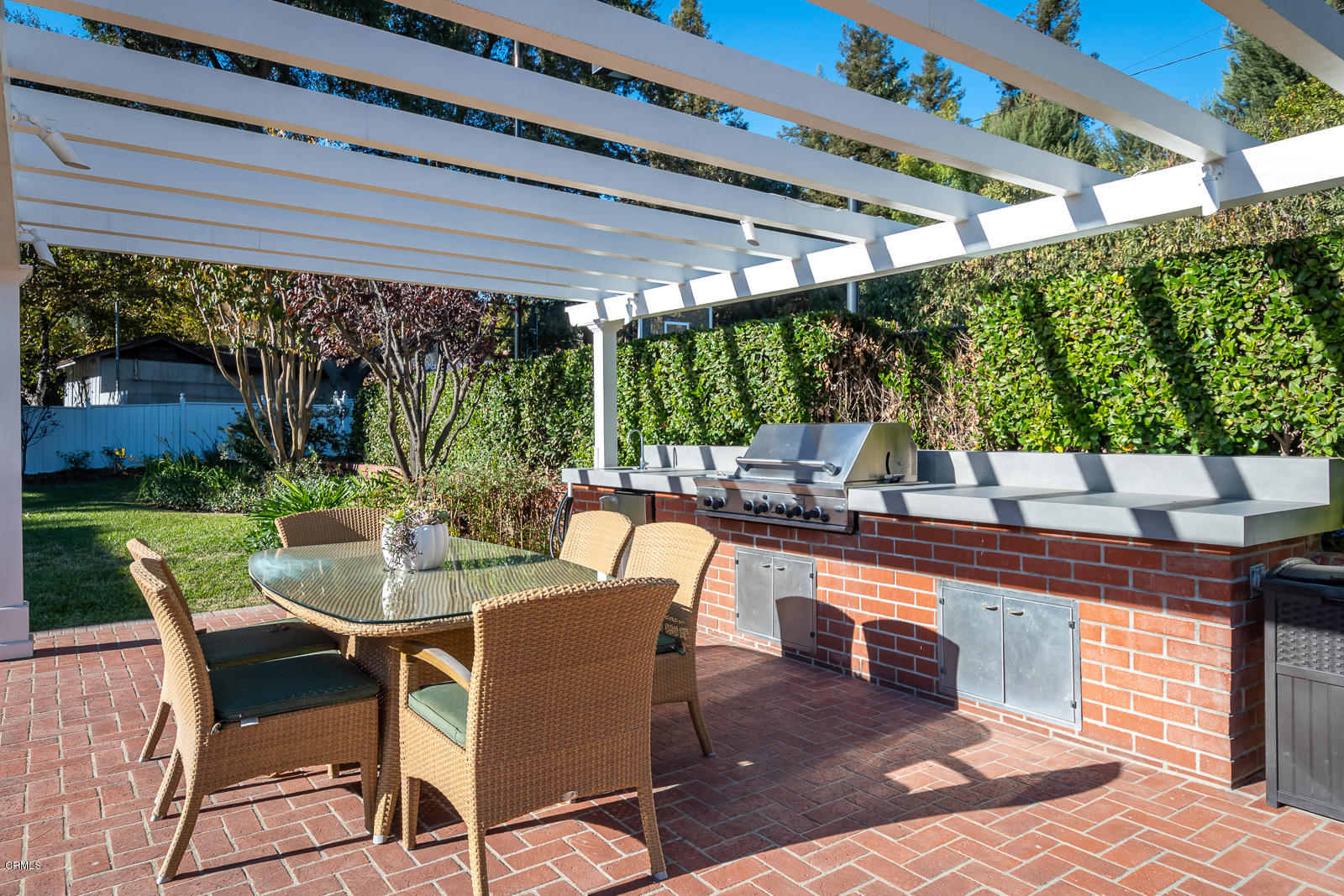 551 Georgian Road La Canada Flintridge, CA 91011 - Photo 50 of 56 a view of a patio with a dining table and chairs with a wooden floor