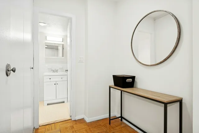 a view of a livingroom with wooden floor and staircase
