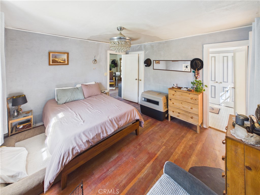 4208 Ramsden Road Mariposa, CA 95338 - Photo 16 of 42 a bedroom with a bed and wooden floor