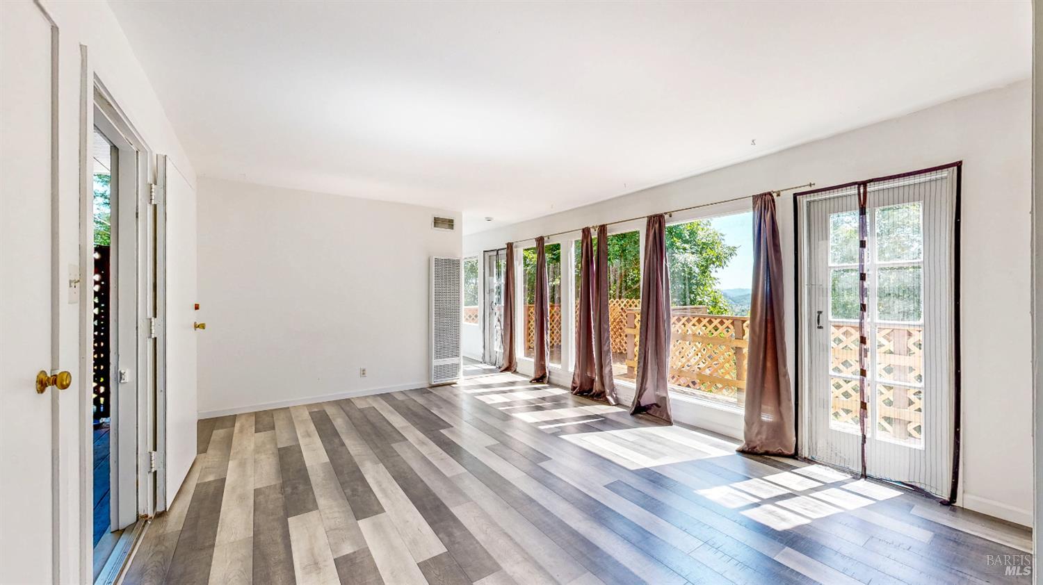 295 Scenic Road Fairfax, CA 94930 - Photo 6 of 17 a view of a room with wooden floor and doors