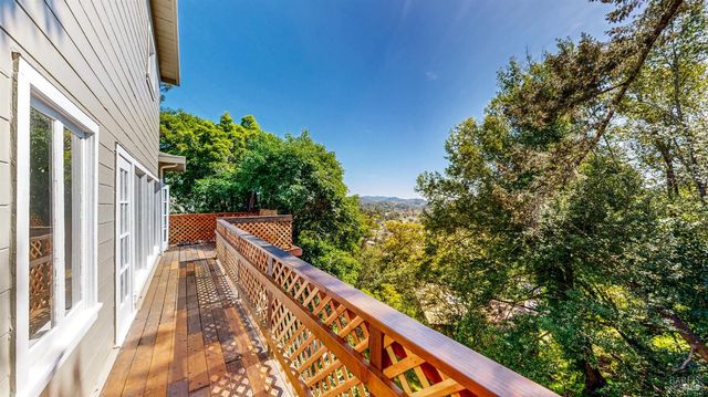 a view of balcony with wooden floor and fence