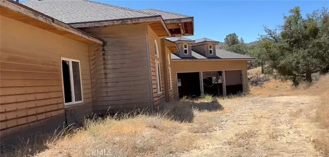 a view of a door and chair in the backyard