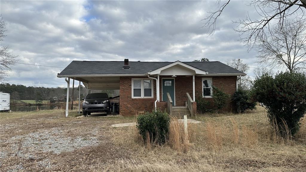 7040 Alan Thomas Road Dawsonville, GA 30534 - Photo 1 of 7 a front view of house with yard and seating