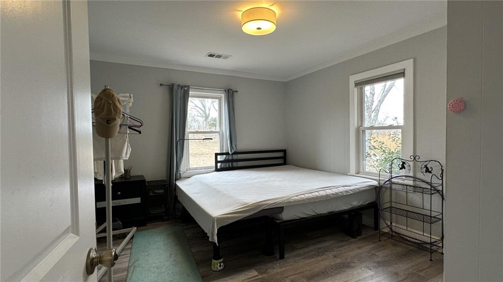 7040 Alan Thomas Road Dawsonville, GA 30534 - Photo 4 of 7 a bedroom with a bed and a window