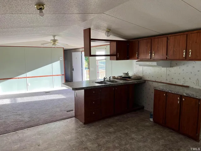 a kitchen with a sink and a refrigerator