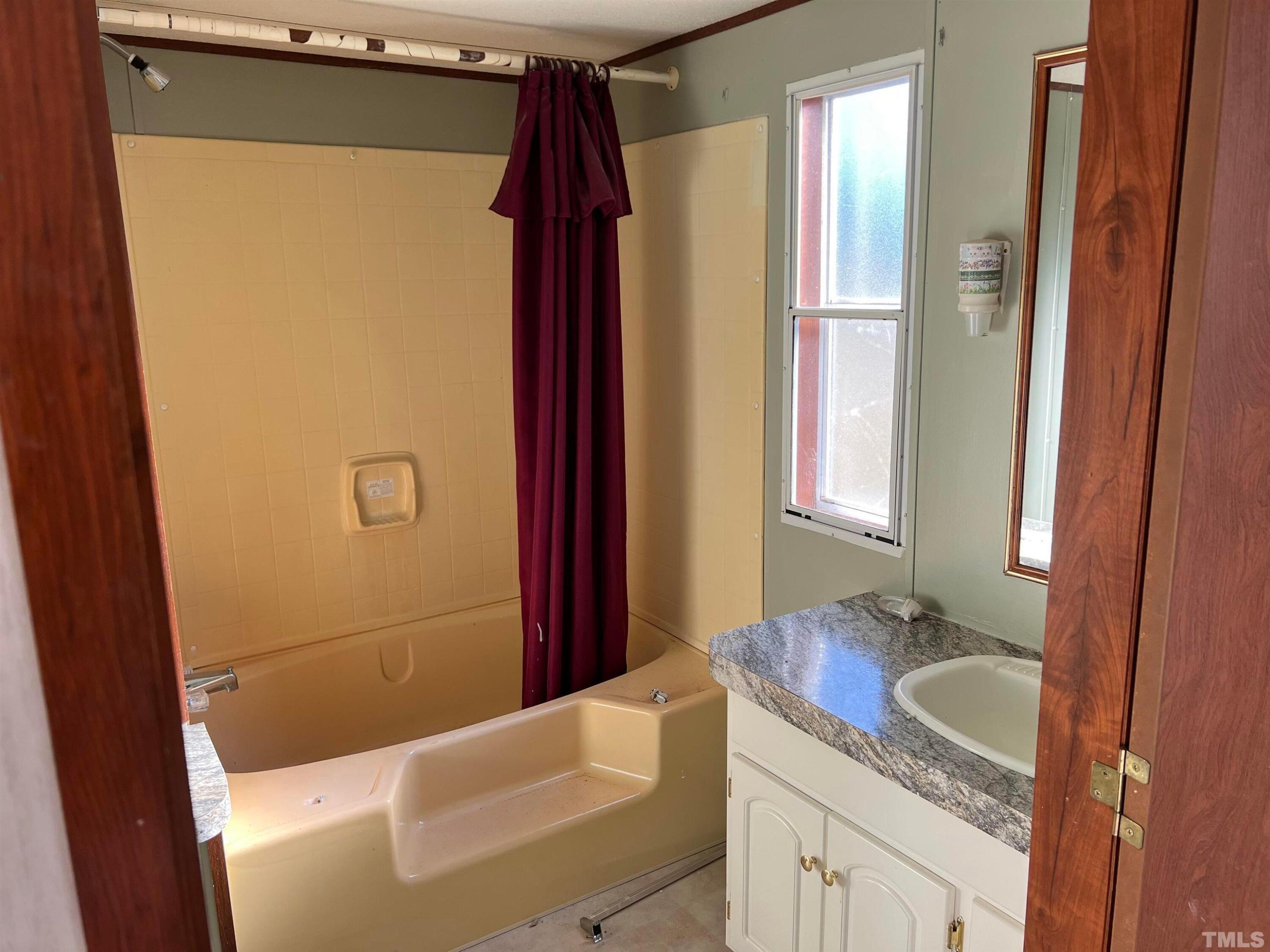 56 Pine Forest Way Louisburg, NC 27549 - Photo 6 of 9 a bathroom with a granite countertop sink and a mirror