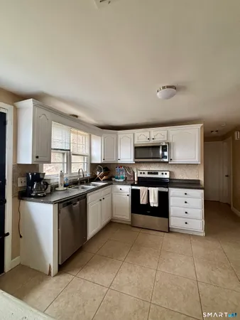 a kitchen with stainless steel appliances granite countertop a stove and a sink