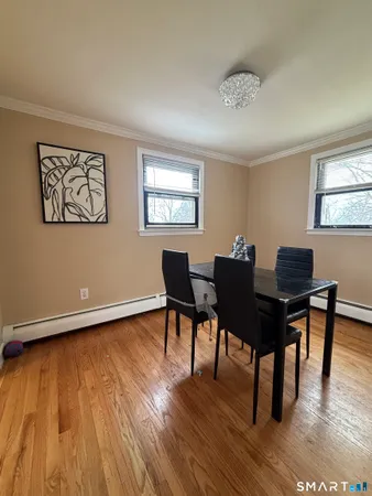 a view of a workspace with furniture and wooden floor