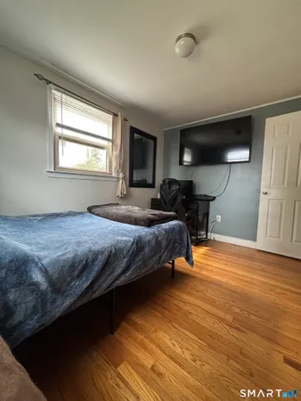 a bedroom with bed and window