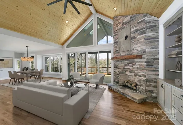 a living room with fireplace furniture and a floor to ceiling window