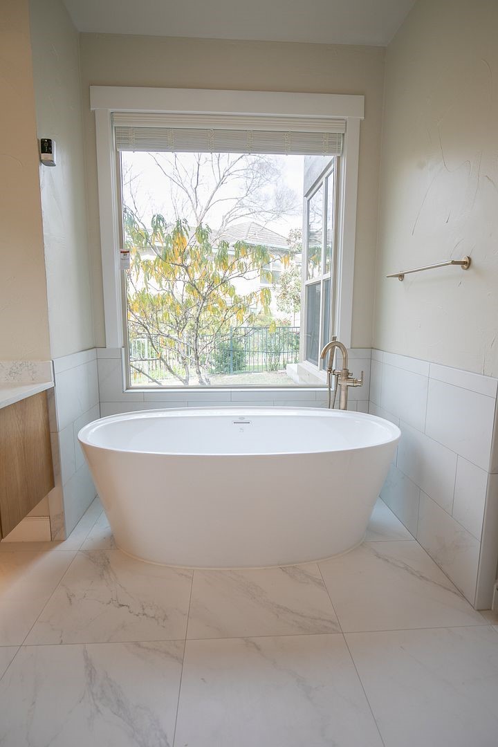 2800 Waymaker Way, Unit 29 Austin, TX 78746 - Photo 12 of 25 a bathroom with a bathtub and large window