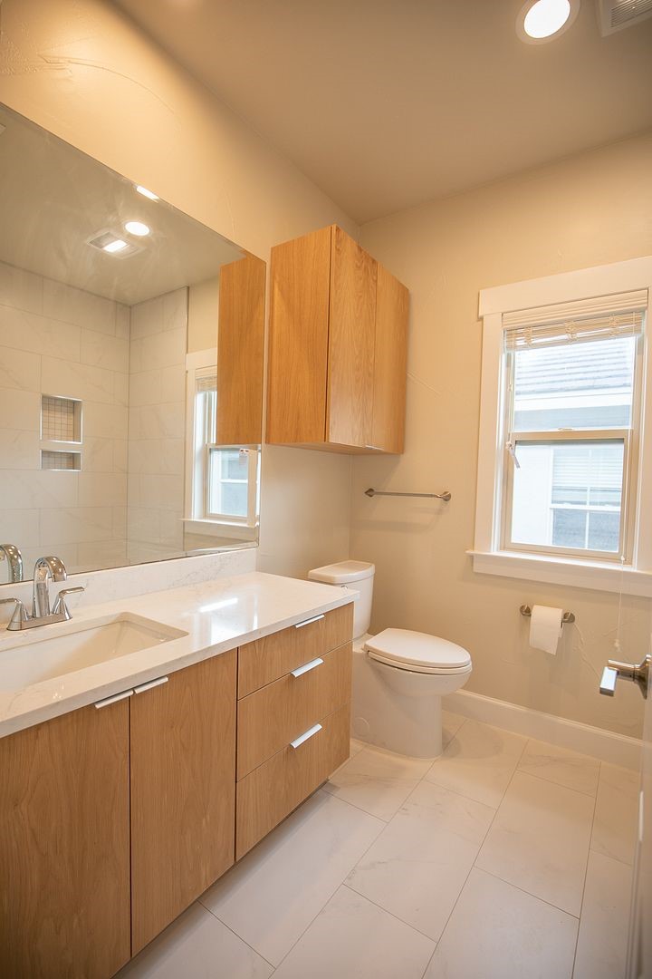 2800 Waymaker Way, Unit 29 Austin, TX 78746 - Photo 20 of 25 a bathroom with a granite countertop sink mirror vanity and toilet