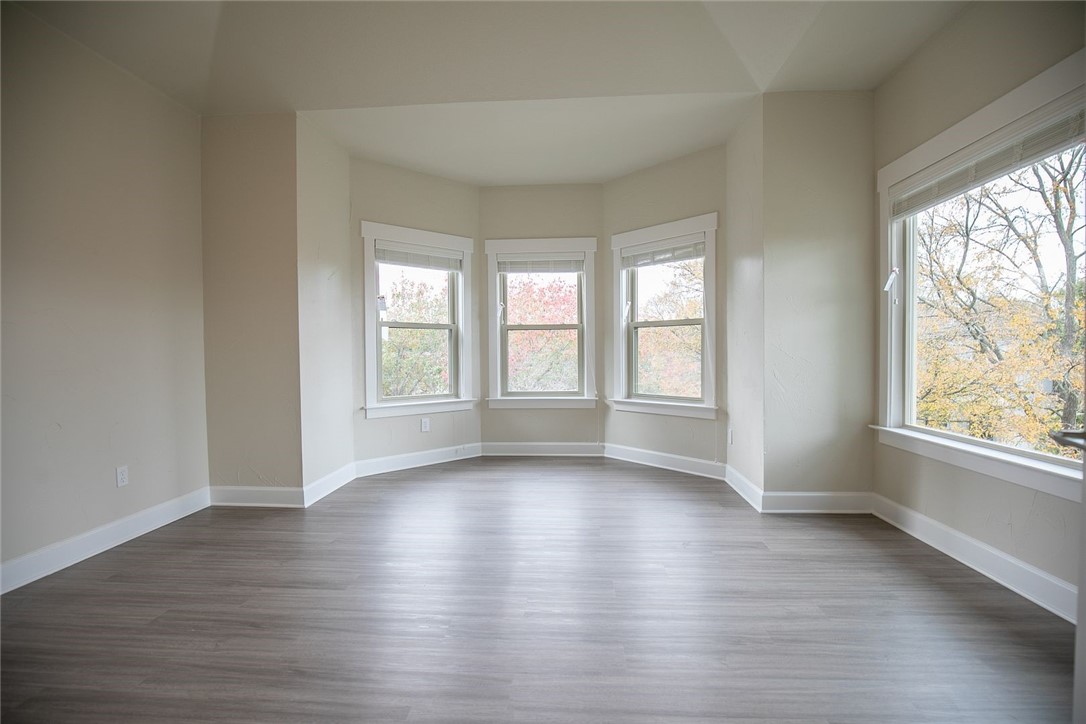 2800 Waymaker Way, Unit 29 Austin, TX 78746 - Photo 22 of 25 a view of an empty room with wooden floor and a window