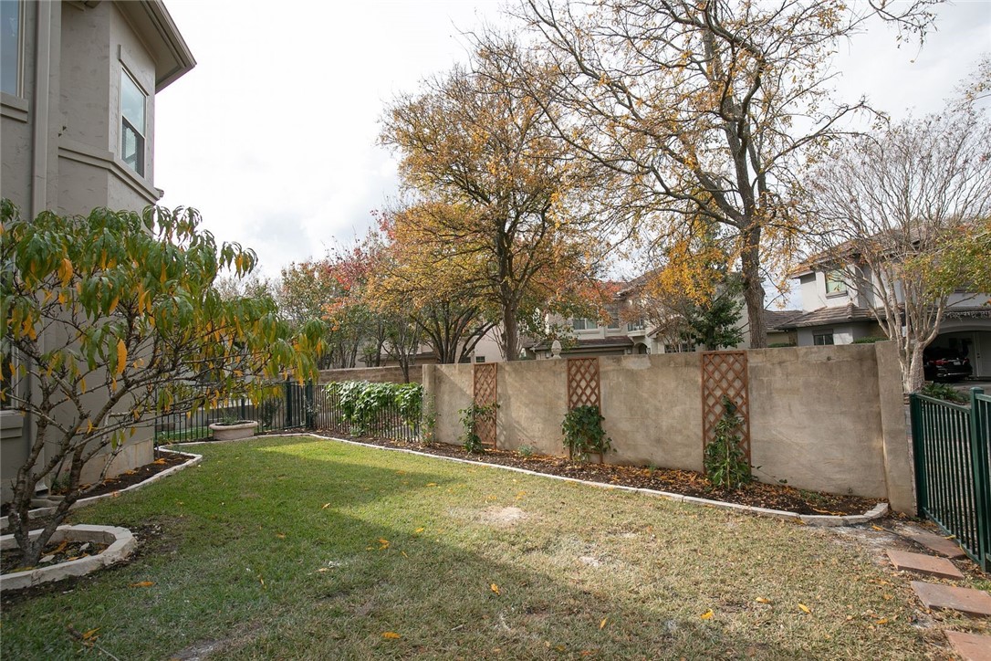 2800 Waymaker Way, Unit 29 Austin, TX 78746 - Photo 25 of 25 a backyard of a house with lots of green space and lake view