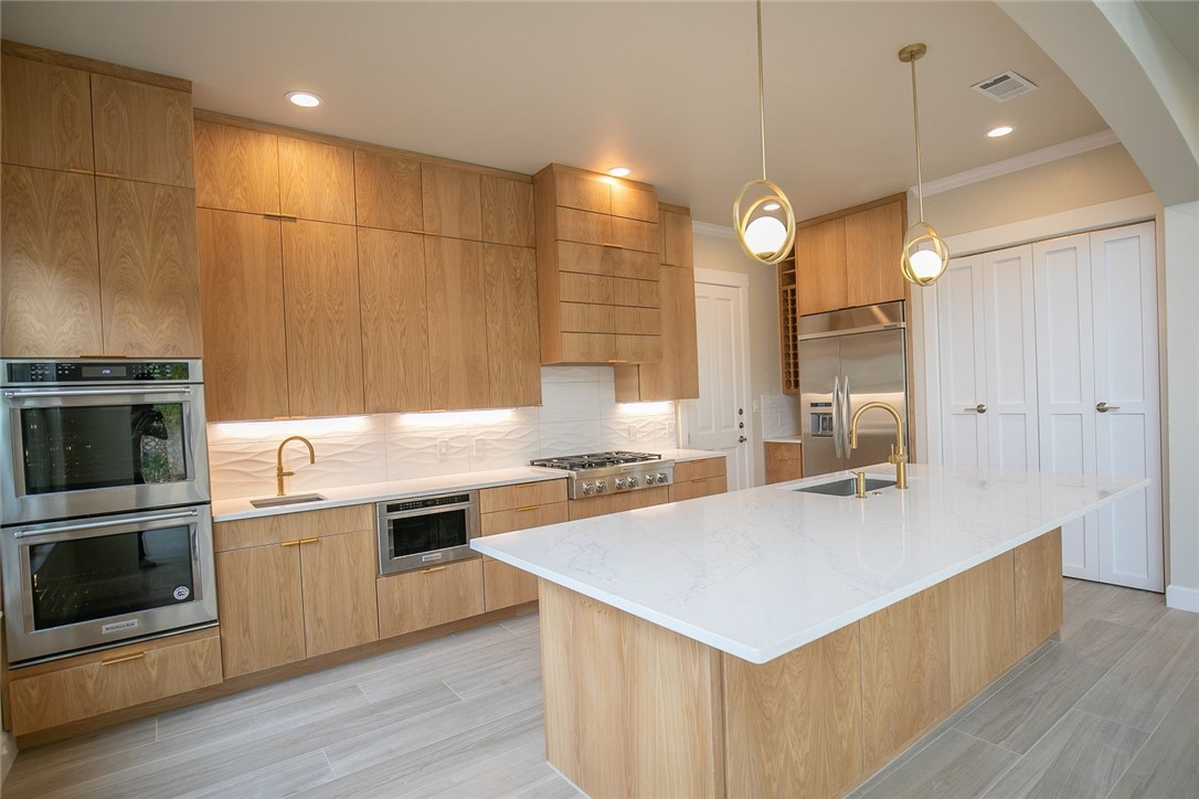 2800 Waymaker Way, Unit 29 Austin, TX 78746 - Photo 5 of 25 a kitchen with a stove and a sink