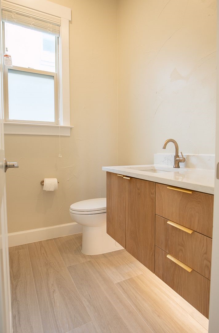 2800 Waymaker Way, Unit 29 Austin, TX 78746 - Photo 9 of 25 a bathroom with a sink a toilet and a window