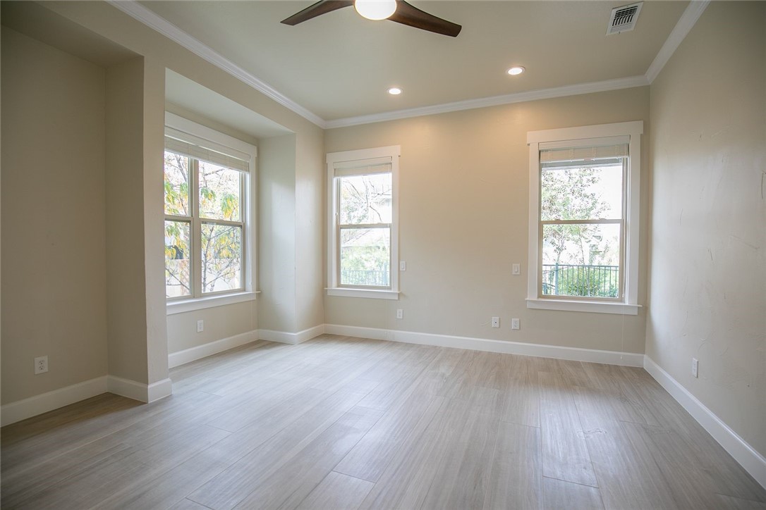 2800 Waymaker Way, Unit 29 Austin, TX 78746 - Photo 10 of 25 a view of an empty room with wooden floor and a window