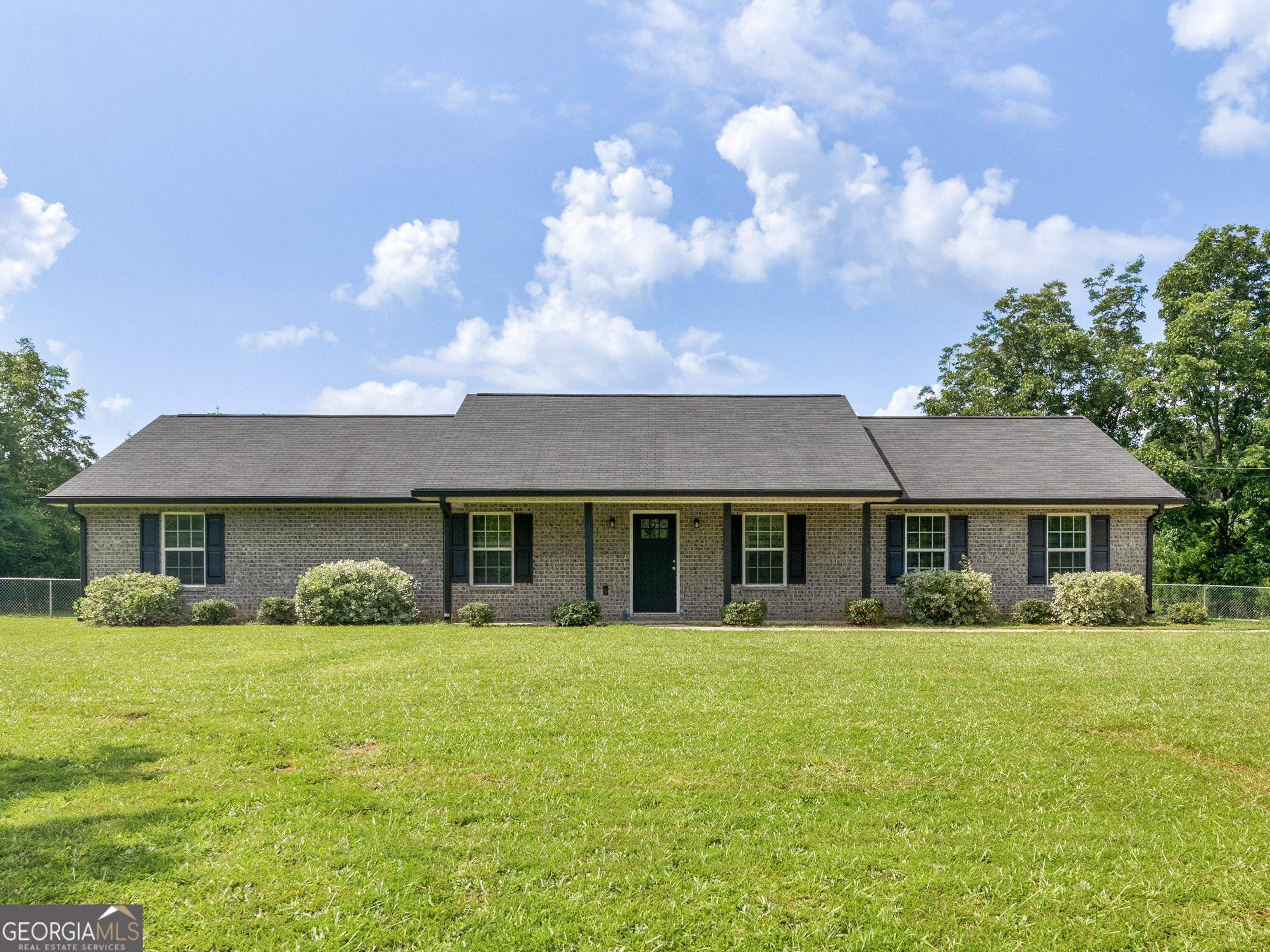 a front view of house with yard and green space