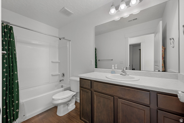 1708 North 1280th Street East Payson, UT 84651 - Photo 11 of 15 Full bathroom featuring a white tub/shower combination, dark wood-finish vanity with an integrated sink, expansive vanity mirror, and wood-finish flooring