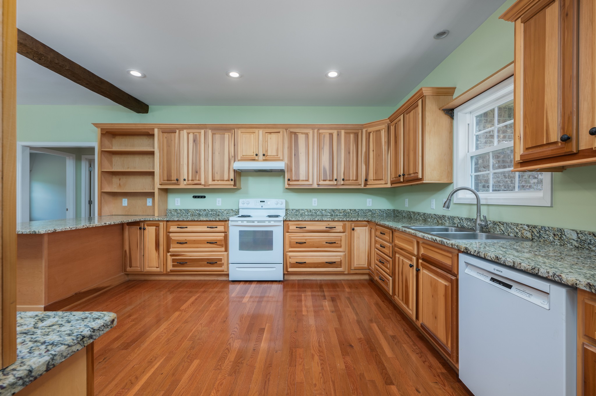 7540 Joe Rowlin Road Christiana, TN 37037 - Photo 11 of 42 a kitchen with stainless steel appliances wooden floors and wooden cabinets