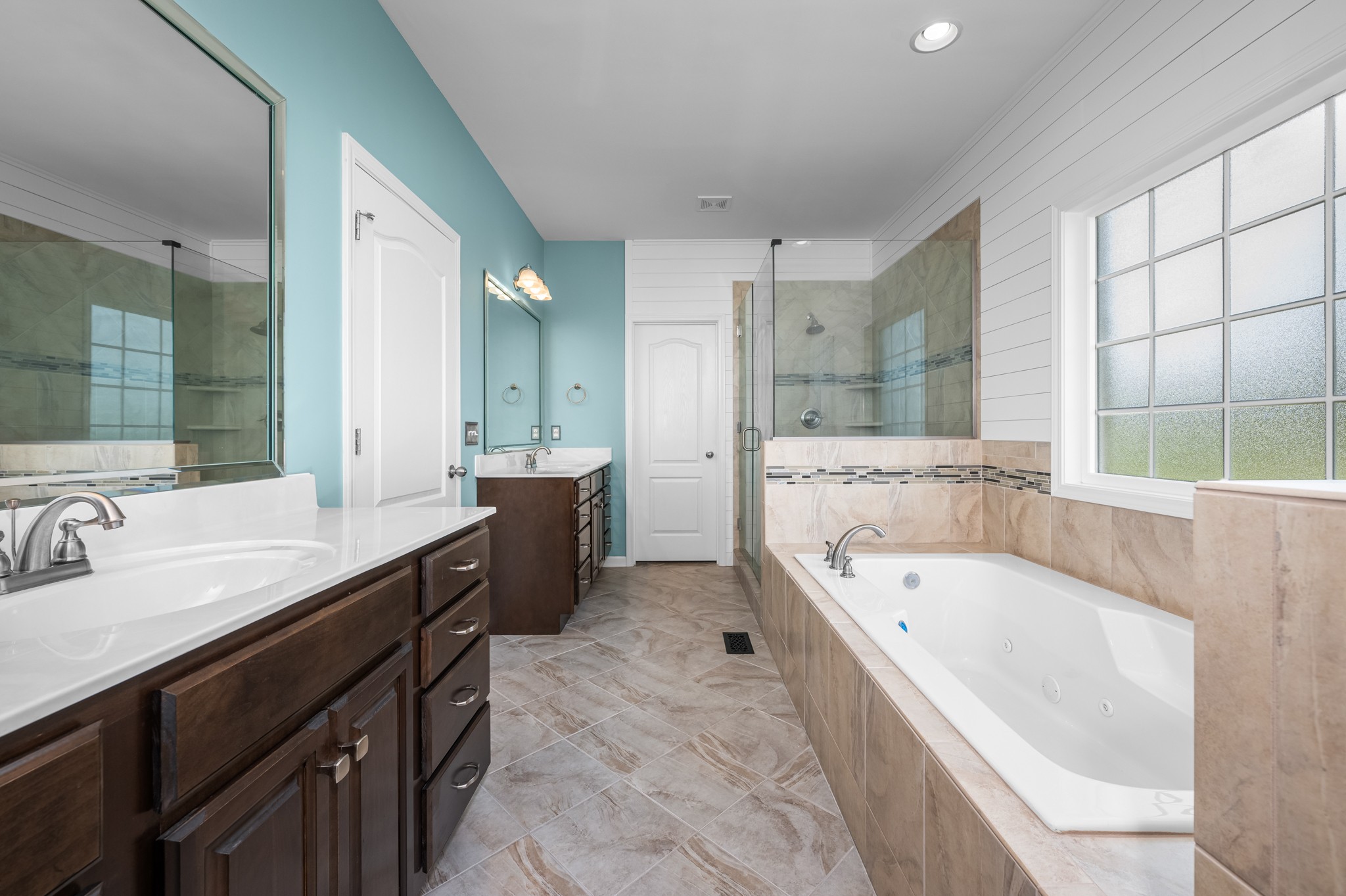 7540 Joe Rowlin Road Christiana, TN 37037 - Photo 18 of 42 a bathroom with a bathtub a double vanity sink and mirror