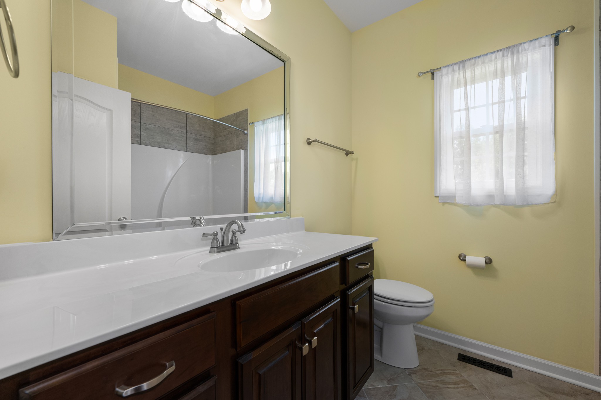 7540 Joe Rowlin Road Christiana, TN 37037 - Photo 20 of 42 a bathroom with a granite countertop sink a toilet and a mirror