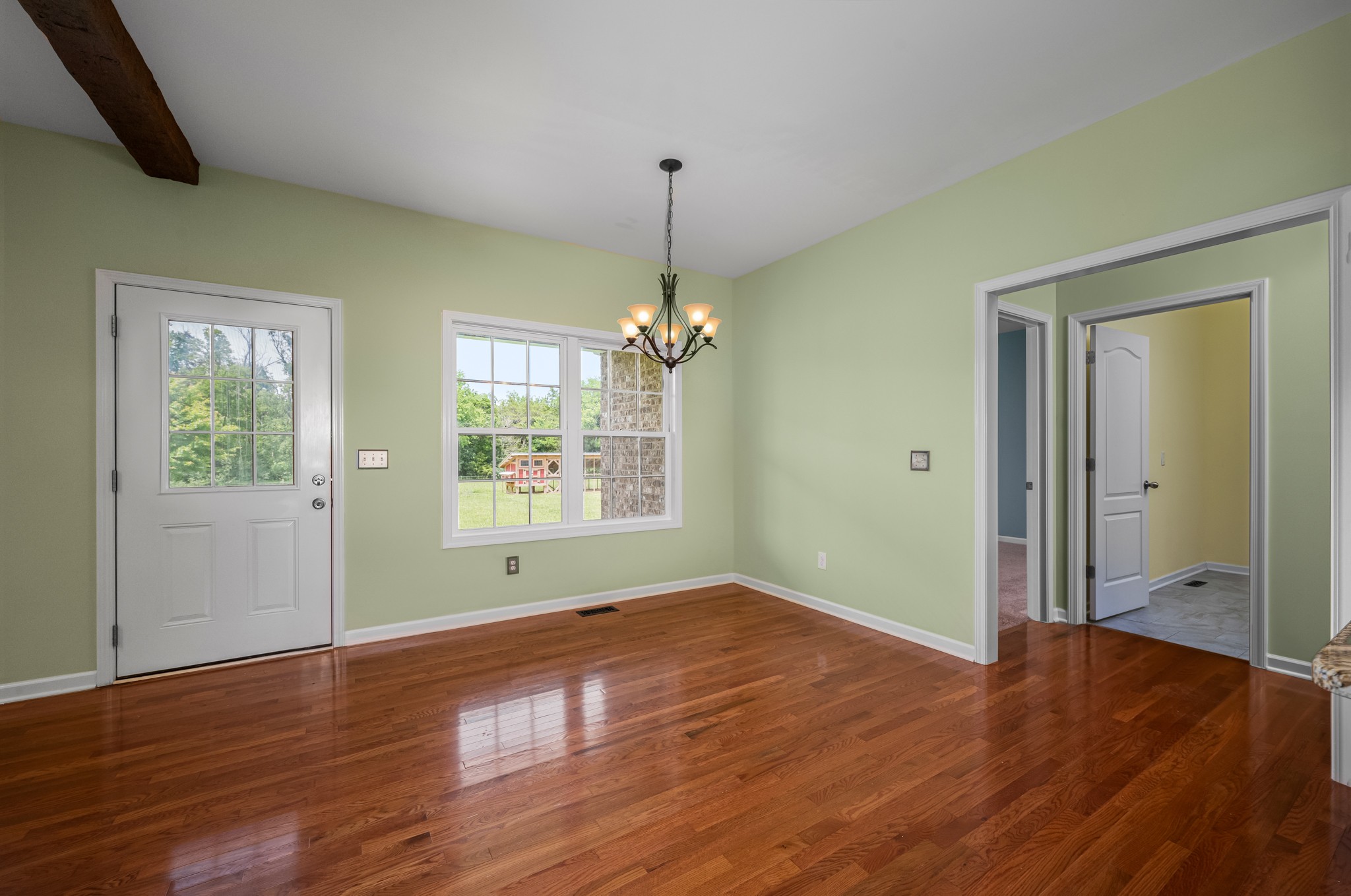 7540 Joe Rowlin Road Christiana, TN 37037 - Photo 7 of 42 a view of an empty room with wooden floor and a window