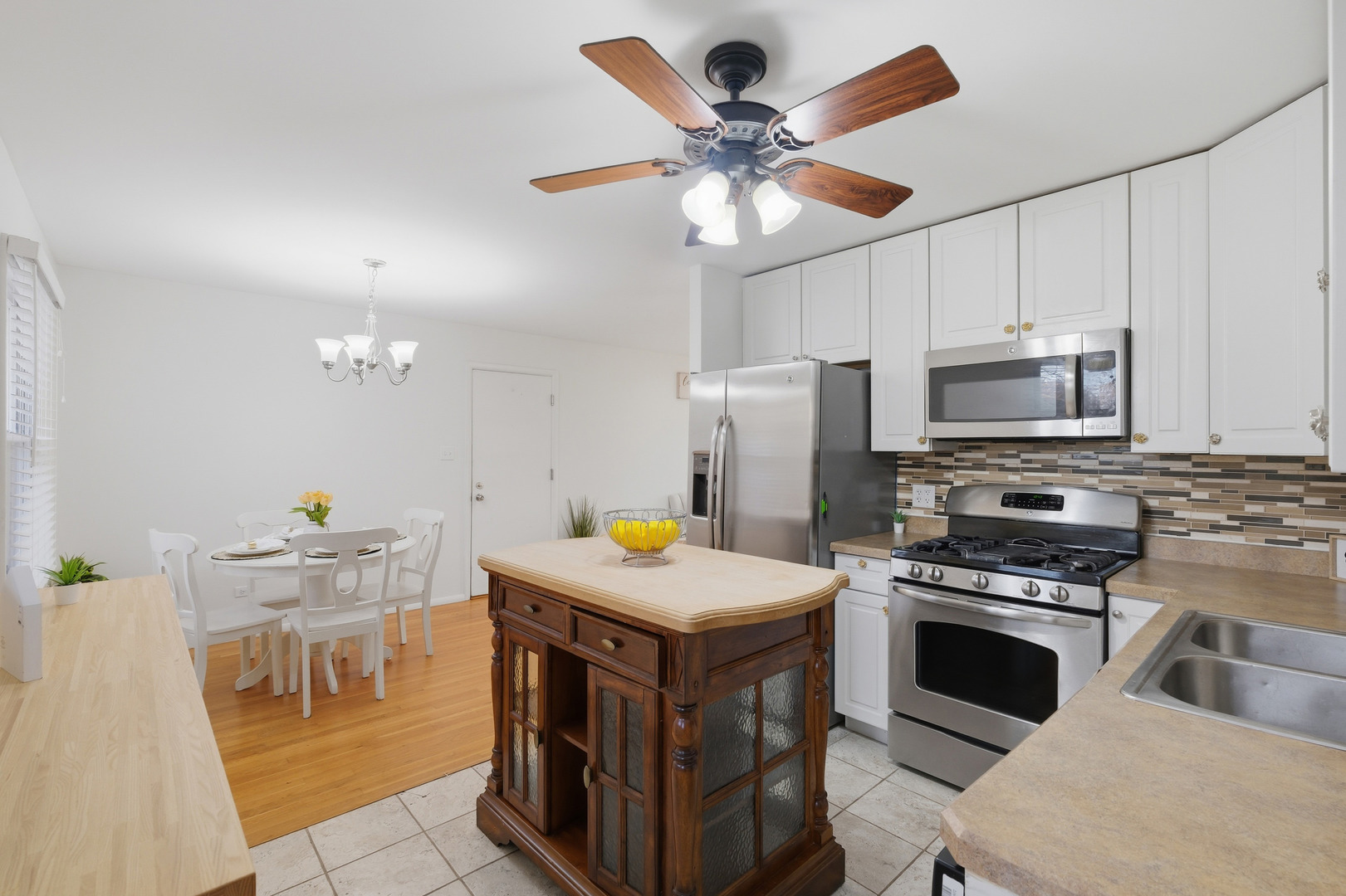 3208 Wren Lane Rolling Meadows, IL 60008 - Photo 8 of 30 a kitchen with a stove a refrigerator and a microwave