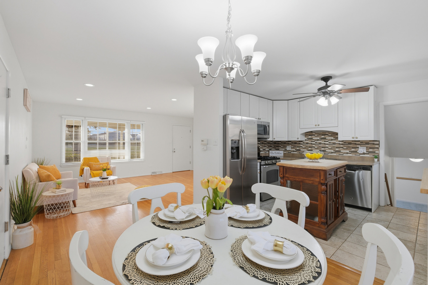 3208 Wren Lane Rolling Meadows, IL 60008 - Photo 10 of 30 a living room with stainless steel appliances furniture a chandelier and a dining table