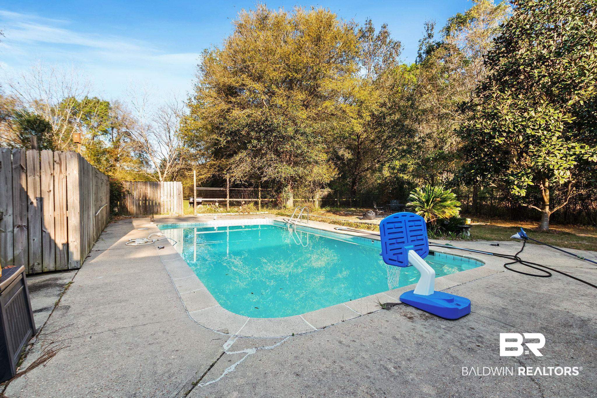 3864 Leroy Stevens Road Mobile, AL 36619 - Photo 29 of 33 View of swimming pool featuring patio surround and a fenced backyard