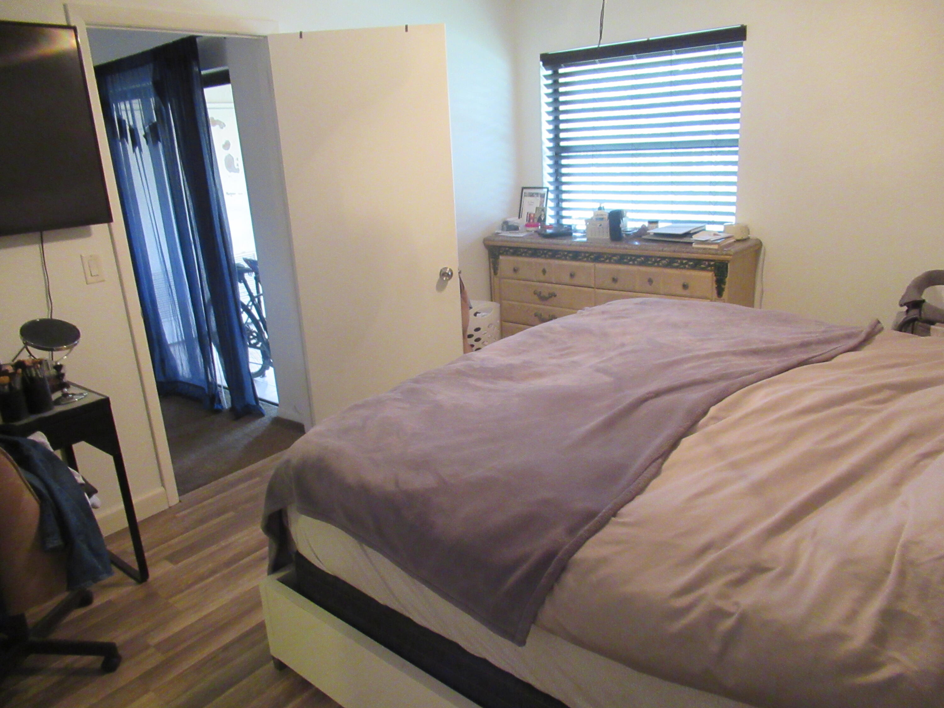 22016 Palms Way, Unit 204 Boca Raton, FL 33433 - Photo 14 of 23 a bedroom with a bed and a flat tv screen on dresser