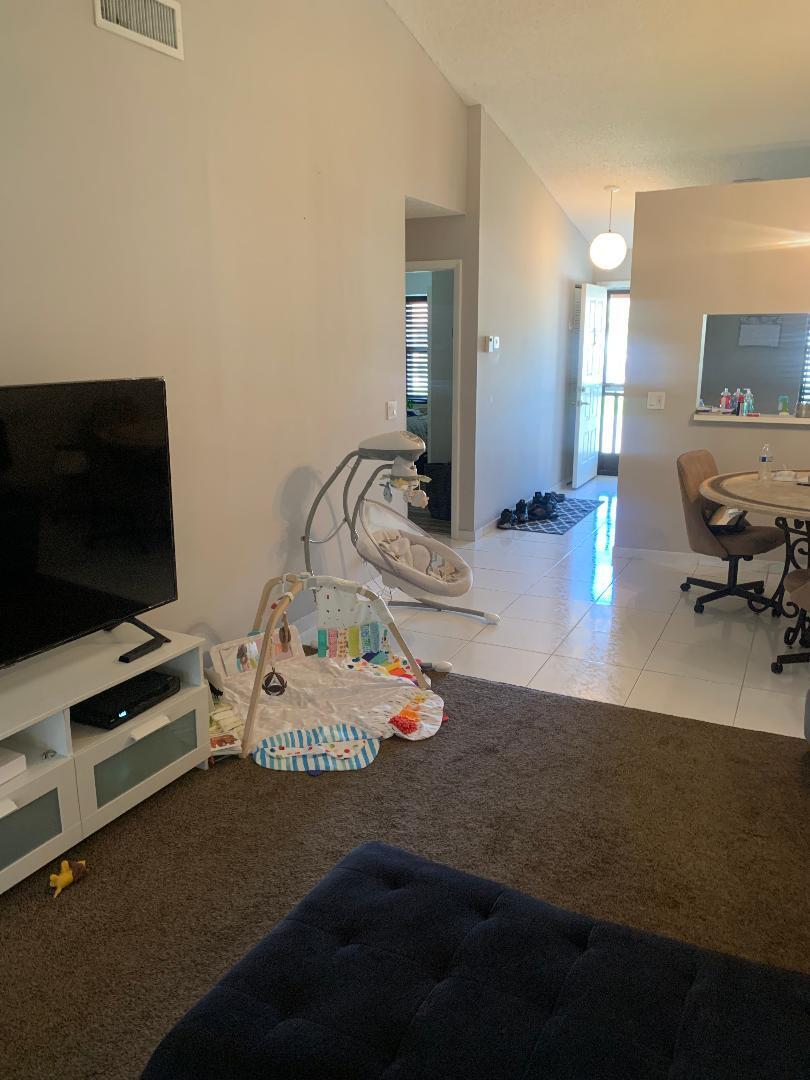 22016 Palms Way, Unit 204 Boca Raton, FL 33433 - Photo 6 of 23 a living room with furniture and a flat screen tv