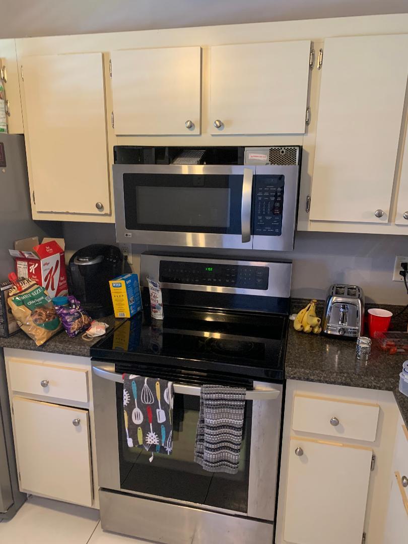 22016 Palms Way, Unit 204 Boca Raton, FL 33433 - Photo 8 of 23 a kitchen with a stove and cabinets