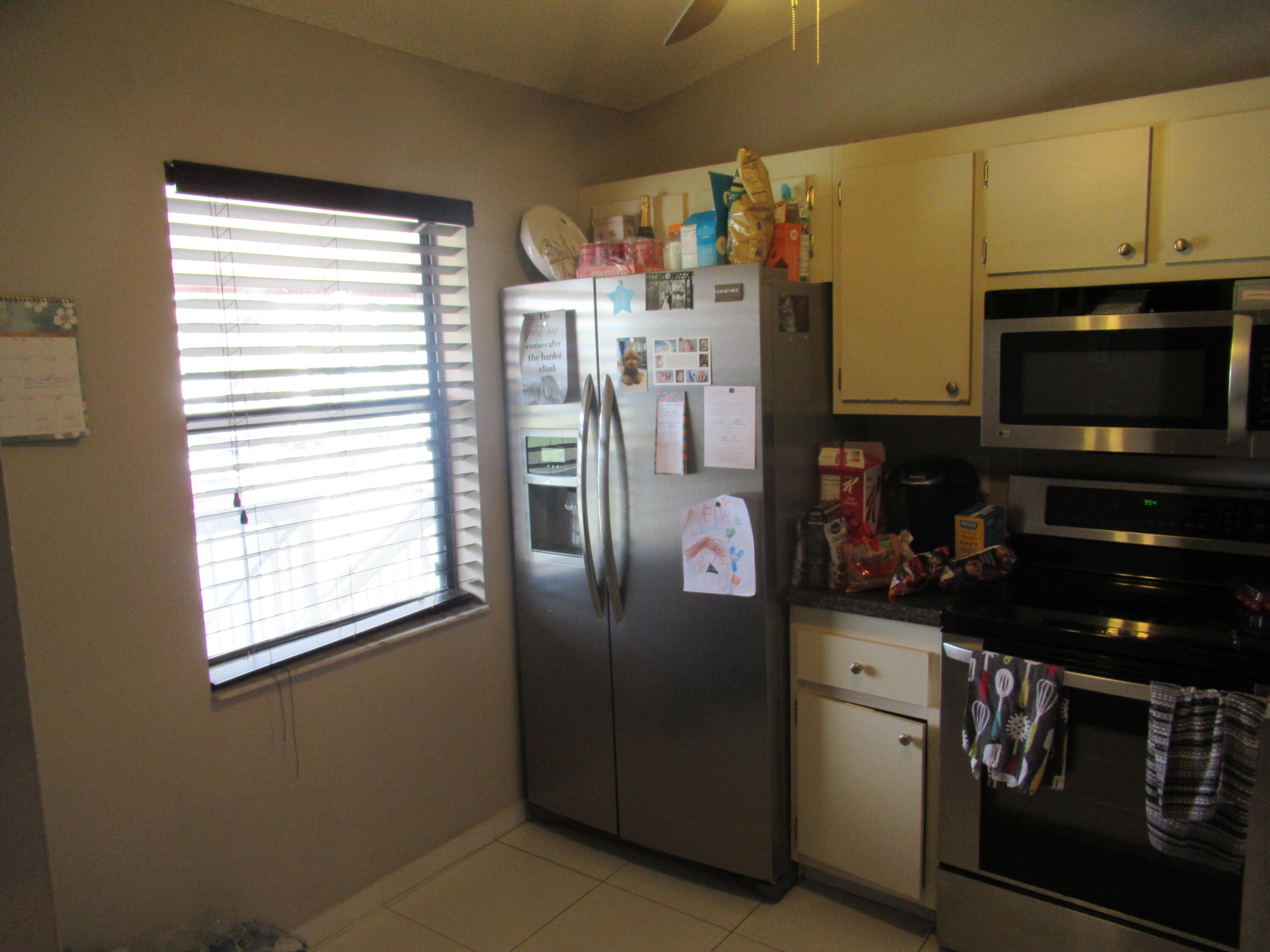 22016 Palms Way, Unit 204 Boca Raton, FL 33433 - Photo 10 of 23 a kitchen with stainless steel appliances a stove a refrigerator a sink a stove and cabinets